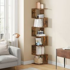 a living room filled with furniture and a book shelf next to a white couch on top of a hard wood floor