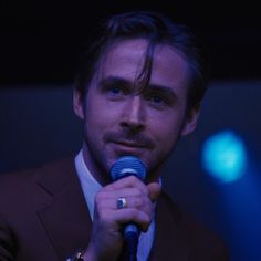 a man in a suit holding a microphone