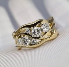 two gold wedding rings with diamonds on them