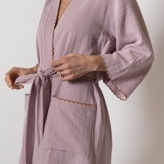 Wrap up in the softest kimono style robe! Made from lightweight and breathable combed cotton, with contrast scalloped edge detailing. Finished with patch style pockets and bracelet length sleeves. The perfect beach cover-up or just for lounging at home, this will be a staple in your Summer wardrobe. Features -Scalloped edges -Two patch front pockets -Waist tie with side belt loops -Bracelet length sleeves Please Note: Monogrammed items are hand stitched and may take up to 5 business days for pro Chic Summer Sleep Robe, Summer Robe With Lace Trim For Daywear, Cotton Sleepwear With Kimono Sleeves, Cotton Sleepwear With Kimono Sleeves For Loungewear, Summer Daywear Robe, Spring Sleepwear With Pockets For Relaxation, Cotton Open Front Robe For Loungewear, Open Front Cotton Robe For Loungewear, Spring Robe With Lace Trim For Loungewear