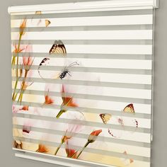 the blinds are closed with flowers and butterflies on them in front of a striped wall