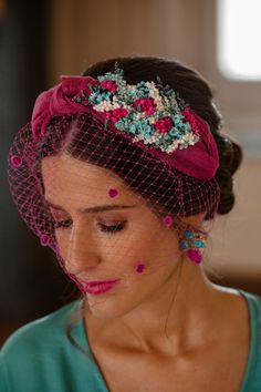 a woman wearing a veil with flowers on it