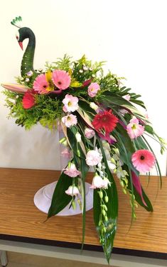 a vase filled with flowers on top of a wooden table