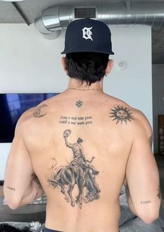 a man with a tattoo on his back riding a horse and saying, don't ride the bull