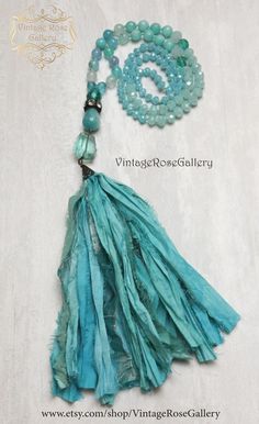 Sari Silk Tassel  Necklace, Aqua Silk Tassel Necklace, Turquoise Agate Jade  Boho Chic Necklace, Statement Necklace ''Mermaid Necklaces " A gorgeous hand made  Sari silk tassel Turquoise Necklace . Features antique rhinestones,  beautiful light blue  Agate gemstones 8mm ,  a large Aqua Quartz ,  a large jade gemstone,  antique copper findings , Czech glass   and a beautiful hand made Sari Turquoise Silk tassel !!!This necklace is so beautiful ...  It is full of Aqua colours !!! The Agate gemston Turquoise Bohemian Tassel Necklace, Turquoise Beaded Necklaces With Tassels For Gift, Turquoise Necklace With Tassels And Round Beads, Turquoise Necklaces With Tassel And Round Beads, Adjustable Turquoise Tassel Necklaces, Bohemian Turquoise Tassel Necklace (adjustable), Bohemian Adjustable Turquoise Tassel Necklace, Bohemian Turquoise Tassel Necklace, Adjustable, Bohemian Turquoise Necklaces With Tassels