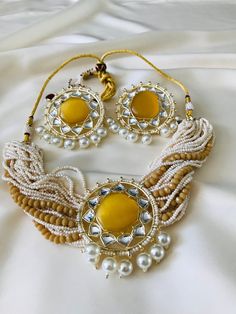 Enhance your elegance with our beautiful Choker with Pendant Necklace and Earrings Set. Available in four enchanting colors - yellow, pink, dark green, and mehandi green - choose the shade that complements your style and radiates your unique beauty. Perfect for brides or special occasions, this stunning Kundan set features delicate pearls, beads, and gold plating, adding a touch of sophistication to any ensemble. Kundan Jewellery Bridal, Jewelry Kundan, Pendant Choker Necklace, Beautiful Chokers, Kundan Jewelry, Pendant Choker, Pink Dark, Jewelry Bridal, Unique Beauty