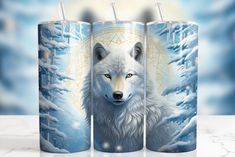 three white wolf mugs sitting next to each other on a marble surface with snow and trees in the background