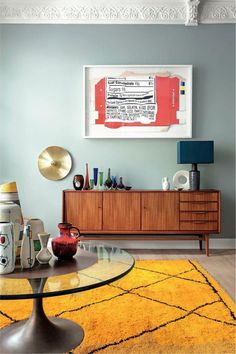 a modern living room with yellow rug and blue walls