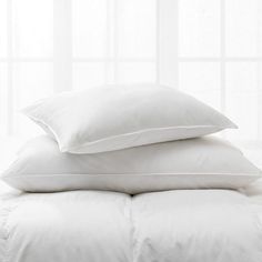 three white pillows stacked on top of each other