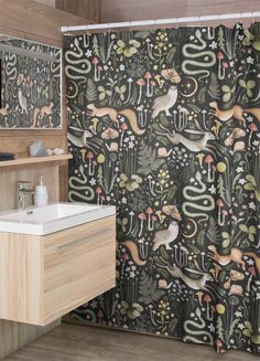 a shower curtain with an image of animals and plants in the forest on black background