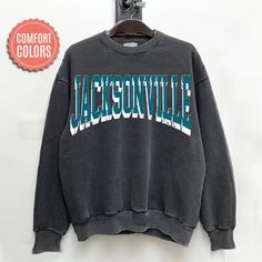 "comfort colors Jacksonville Football sweatshirt, Jacksonville Football Shirt, Jacksonville Football Gift -Please check Color and Size Charts before placing the order. You can find them in the listing's photos (Depending on what device you are viewing this listing colors may vary slightly). -Returns and exchanges are accepted only if there are defects \"No Extra Costs\" We create custom t-shirts with great designs for everyone's liking. If you don't find the size or color you would like, please message us and we will be happy to  accommodate! comfort colors Jacksonville Football sweatshirt, Jacksonville Football Shirt, Jacksonville Football Gift PRODUCT Sweatshirt Comfort Colors® 1566     80% ring-spun cotton, 20% polyester     Medium-heavy fabric (9.5 oz /yd² (322.1 g/m     Relaxed fit Casual Sweatshirt With Letter Print For Campus, Gray Casual Sweatshirt With Lettering, Casual Gray Sweatshirt With Lettering, Gray Lettering Casual Sweatshirt, Casual Campus Sweatshirt With Lettering, Casual Soft-washed Sweatshirt For College, Cotton Sweatshirt With Lettering For Campus, Casual Cotton Sweats For Campus, Casual Crew Neck Hoodie For Campus