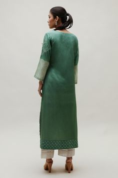 Green silk straight kurta with all over bandhani pattern, accentuated with an embroidered yoke in gota patti work.
Components: 1
Pattern: Woven, Embroidery
Type Of Work: Bandhani, Gota Patti
Neckline: Round Neck
Sleeve Type: Full Sleeves
Fabric: Silk
Color: Green
Other Details: 
Length: 48 inches
Note: Pant worn by the model is not for sale

Occasion: Puja - Aza Fashions Elegant Green Kurta With Embroidered Border, Pista Green Chanderi Kurta With Embroidered Border, Transitional Pista Green Kurta With Embroidered Border, Green Slub Silk Traditional Wear With Embroidered Border, Pista Green Embroidered Wedding Kurta, Green Raw Silk Kurta With Embroidered Border, Pista Green Embroidered Kurta, Fitted Pista Green Kurta With Embroidered Border, Elegant Pista Green Traditional Wear With Embroidered Border