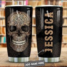 two black and gold tumblers with an image of a skull on the front one