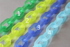 four different colors of plastic chain bracelets with numbers on each side and the number 1, 2, 3, 4, or 5