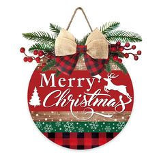 a christmas ornament hanging on a wall with red, green and white plaid ribbon