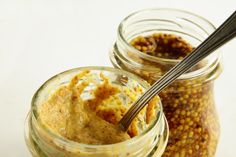 two jars filled with food sitting next to each other