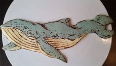 a white plate topped with a cookie shaped like a whale