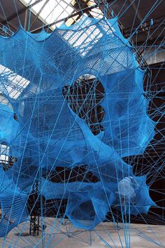 an art installation with blue mesh covering it