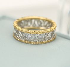 two tone gold and silver wedding band with diamond accents on the inside of each ring