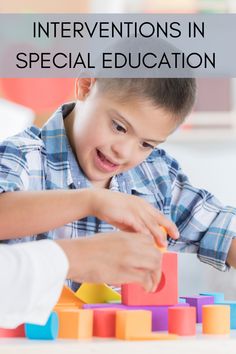 a young boy playing with blocks and toys in front of an adult holding the block