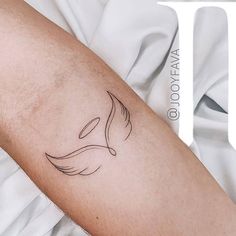 a woman's arm with a tattoo on it that has a bird in the middle