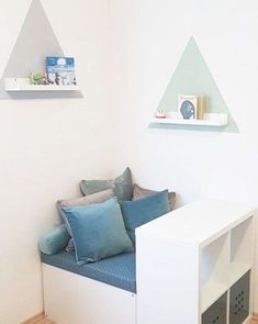 a room with a couch and shelves on the wall