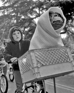 a person riding a bike with a stuffed animal in the basket