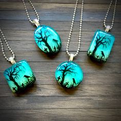 "Spooky Tree Twilight Resin Pendant. This pendant is made from resin and has a fresh, contemporary look. Features a hand painted spooky tree in a field set against a multi-layered twilight scene.  Every pendant is hand painted so the branches and layout will differ slightly each time -  therefore you will own a true one of a kind! Reverse side is white and covered in fine iridescent glitter. Pendant is extremely light to wear and smooth to touch. Available in 4 shapes: rectangle, square, oval an Hand Painted Jewelry For Halloween Gift, Halloween Gift Resin Jewelry, Halloween Resin Jewelry Gift, Handmade Resin Jewelry For Halloween, Hand Painted Resin Pendant Necklaces, Black Resin Pendant Jewelry, God Crafts, Tree In A Field, Artistic Resin Round Pendant Necklace