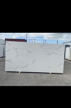 a large white marble slab sitting in a parking lot