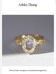 an image of a ring with a stone in it and the words, asley zhang