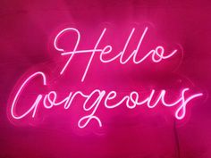 a pink neon sign that says hello gorgeous