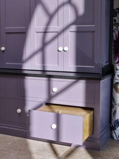 a purple dresser with two drawers in the middle