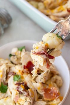 a fork with some food on it in a bowl