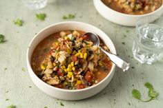 two bowls filled with soup on top of a table