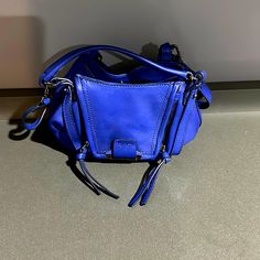 Mini Kooba Cobalt Blue Hand Bag With Small Handles And A Detachable Strap. Ideal For Small Wallet, Phone, Keys And Other Small Items. Contains A Small Inside Pocket And An Exterior Pocket. Completely New, Never Been Used. Makes A Great Gift! Blue Hand, Small Wallet, Small Items, Hand Bag, Cobalt Blue, Mini Bag, Inside Pocket, Cobalt, Handles