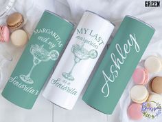 two green and white can coolers with macaroni and cheese on them next to macaroons