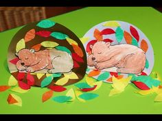 two paper plates sitting on top of a table covered in leaves and bear cut outs