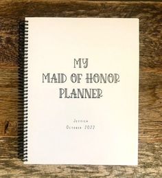 a spiral notebook with the words, my maid of honor planner written in black ink