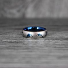 a wedding ring with dolphins painted on it