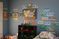 a child's bedroom with license plates on the wall