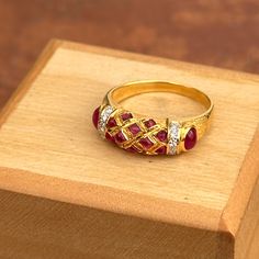 Estate/ vintage 18KT yellow gold Etruscan/ Byzantine design band ring with genuine cabochon red ruby and diamond gemstones. Size: 6.5 Measures: 6.5mm wide 10 Tiny Diamonds .005 carat Weight: 3.90 Grams Stamped 18K Vibrant gold color, almost looks like 22KT Excellent condition Yellow Gold Cabochon Ruby Ring, Fine Jewelry Cabochon Ruby Ring In Yellow Gold, Fine Jewelry Ruby Ring In Yellow Gold With Cabochon, Cabochon Ruby Ring In Yellow Gold, Elegant Ruby Ring With Diamond Settings, Traditional Yellow Gold Ruby Ring, Ruby Cabochon Rings For Anniversary, Cabochon Ruby Ring For Anniversary, Traditional Ruby Ring For Formal Occasions