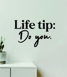 the words life tip do you are written in black on a white wall next to a potted plant