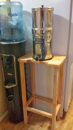 a wooden table sitting next to a water cooler