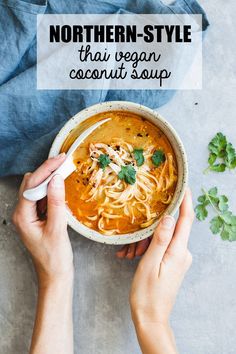 two hands holding a bowl of vegan thai coconut soup with the text, northern - style vegan thai coconut soup