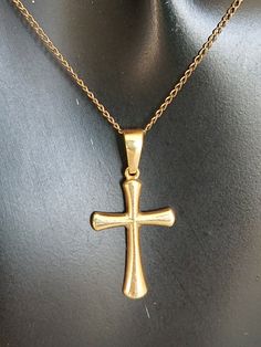 "Featuring this Estate Sale Find 14K Yellow Gold Cross and Chain pendant necklace from the 1980's. The cross is in a plain slightly puffy gold metal with some dents on the backside. Please look at the photos and video. The chain is the original to the cross and is in great vintage condition. This cross pendant would make an excellent gift for that person making their 1st Holy Communion or Baptism. Chain measures: 19\"L Cross measures: 1\"L X 1/2\"W Material: 14K Yellow Gold Cross, 14K Yellow Gol Hallmarked Yellow Gold Cross Pendant Necklaces, Classic Gold Plated Cross Necklace, Classic Gold Cross Necklace, Classic Gold Crucifix Necklace, Vintage Gold Cross Pendant Necklace, Vintage Gold Cross Necklace For Gift, Gold Cross Necklace With Polished Finish, Gold Crucifix Cross Necklace With Polished Finish, Classic Gold Crucifix Cross Necklace