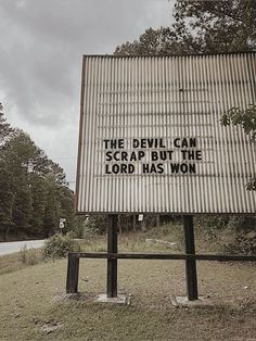 a sign that has been placed on the side of a road saying, the devil can scrap but the lord has won