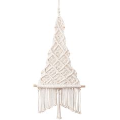 a white christmas tree decoration hanging from a wooden pole with tassels on it