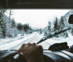 a person driving a car on a snowy road