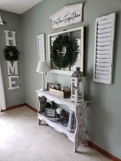 the entryway is decorated with wreaths and shutters on the wall above it