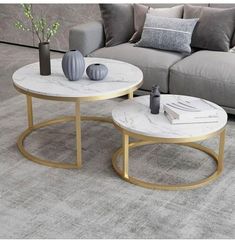 two tables sitting on top of a carpeted floor next to a couch and coffee table